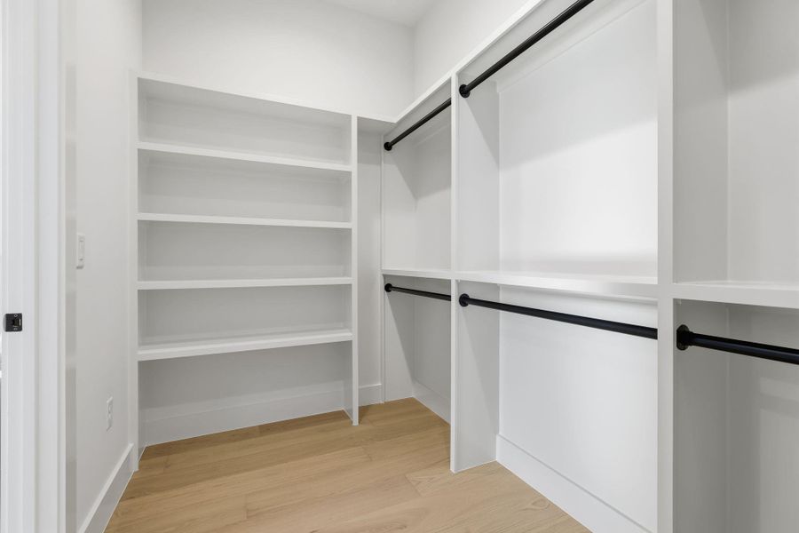 Walk in closet featuring light wood-style floors