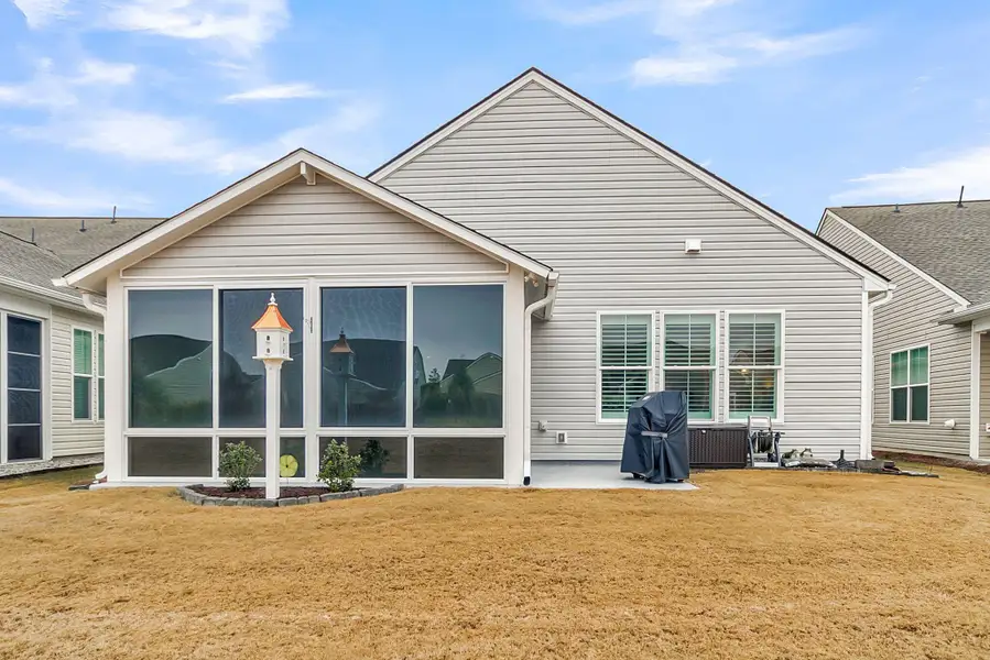 Exterior details and patio area of a home in K. Hovnanian's® Four Seasons at Lakes of Cane Bay, Summerville (Image 3).