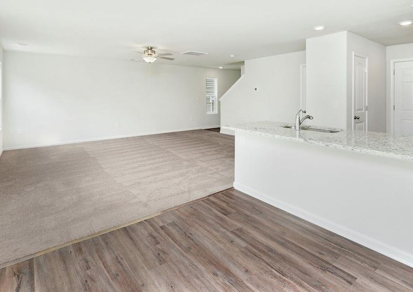 Open floor plan with a kitchen, dining area and living room.