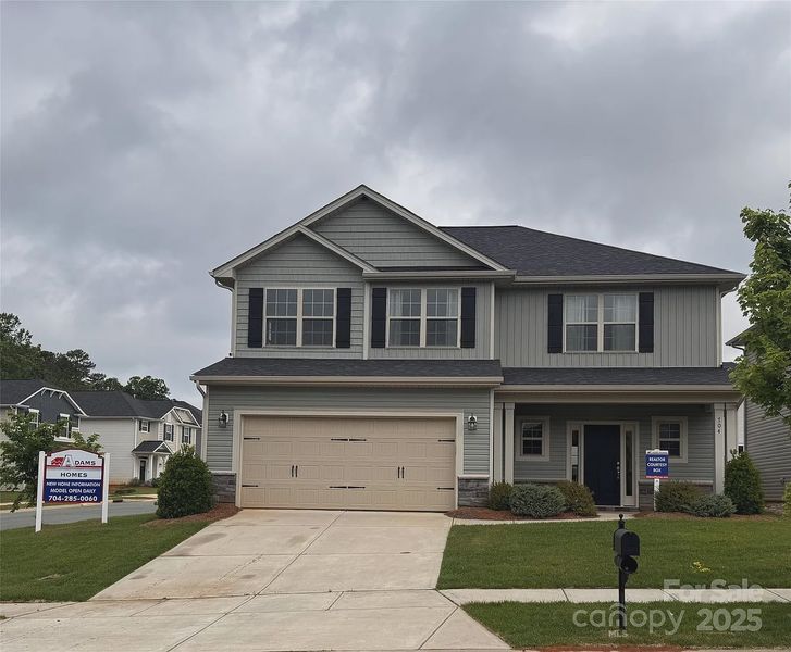 Front exterior of a new home in Village at Parkside, Gastonia, NC, highlighting curb appeal (Image 1).