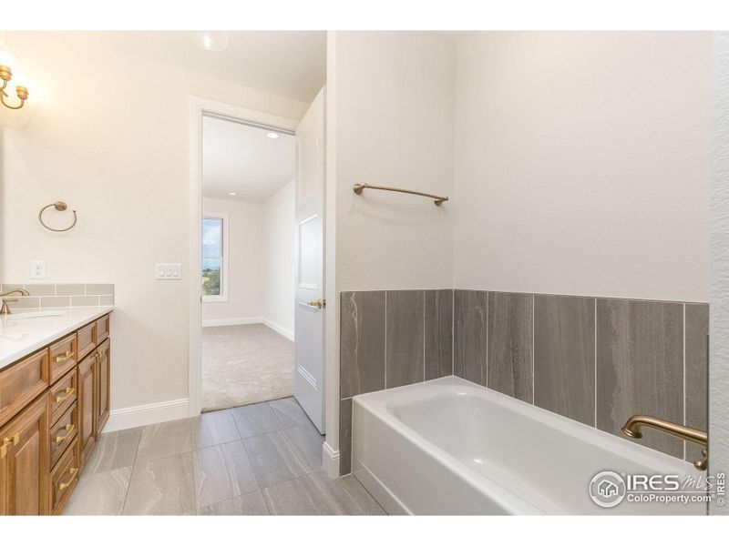 The cast iron soaker tub in the primary ensuite bathroom is ready for spa day!