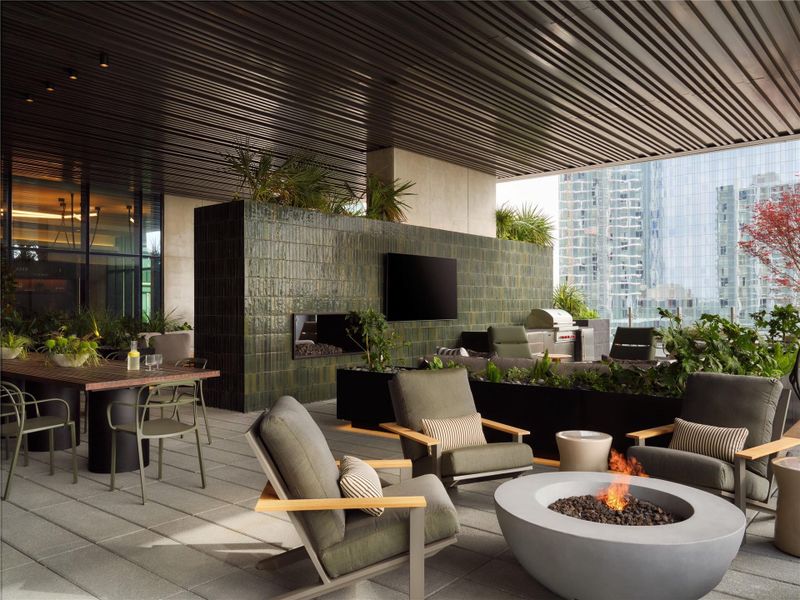 A covered terrace features a modern fire pit, tiled architectural walls, and skyline views. A covered terrace features a modern fire pit, tiled architectural walls, and skyline views.