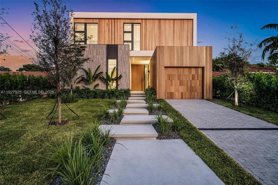Front exterior of a new home in , Surfside, FL, highlighting curb appeal (Image 26). Front exterior of a new home in , Surfside, FL, highlighting curb appeal (Image 26).