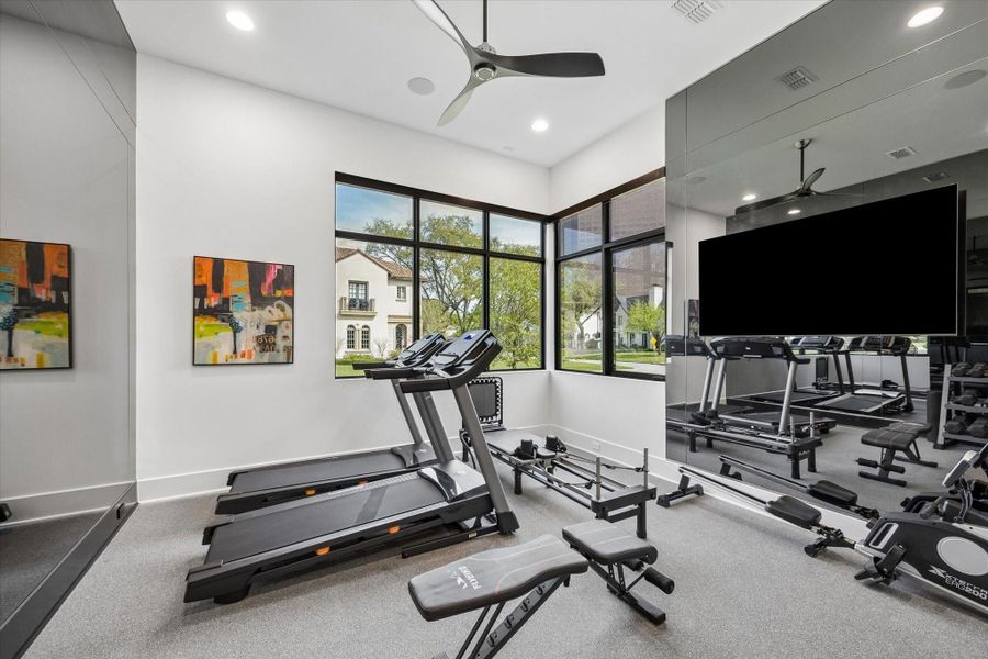 Downstairs bedroom is currently being utilized as a gym. The custom dark grey mirrors add the most elegant and modern touch to the home gym space. There is also a commercial grade red light machine built into the wall the can be removed if this space needs to be used as a bedroom. Downstairs bedroom is currently being utilized as a gym. The custom dark grey mirrors add the most elegant and modern touch to the home gym space. There is also a commercial grade red light machine built into the wall the can be removed if this space needs to be used as a bedroom.