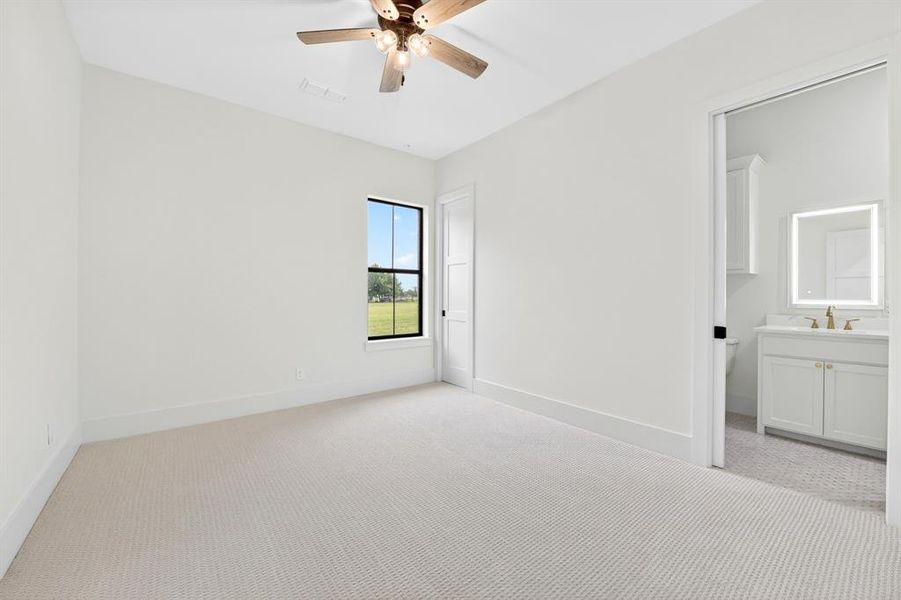 One of 3 secondary bedrooms located downstairs with ensuite full  bath