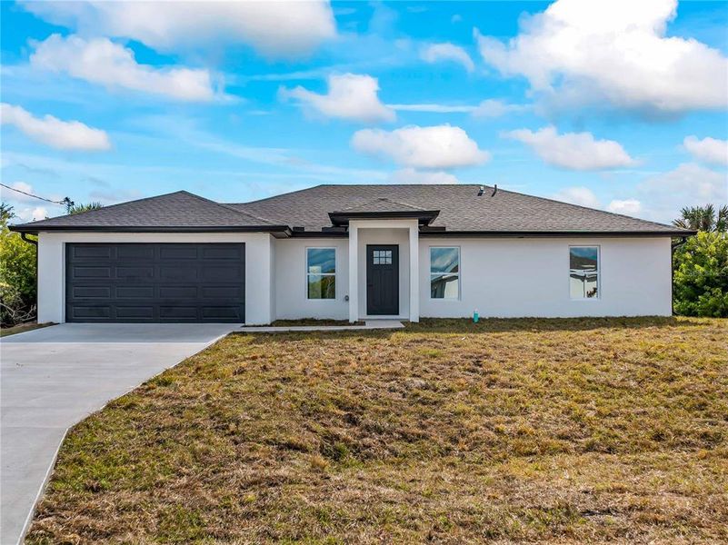Front exterior of a new home in , Port Charlotte, FL, highlighting curb appeal (Image 28).