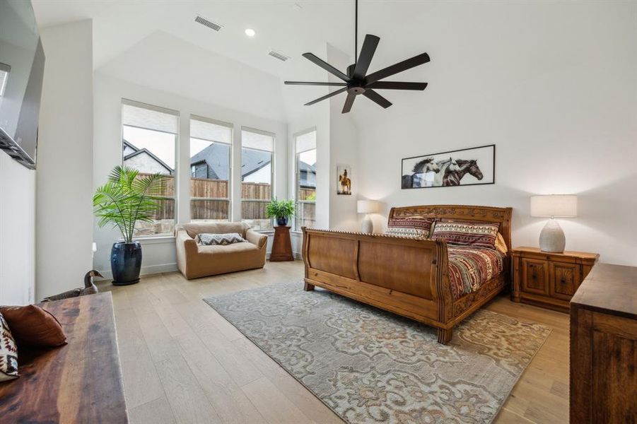 Bedroom featuring light wood-style floors, high vaulted ceiling, ceiling fan, and recessed lighting