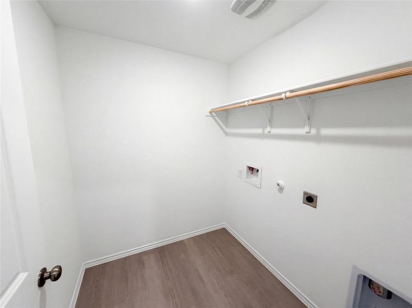 Laundry area featuring hookup for an electric dryer, gas dryer hookup, dark wood-style floors, and hookup for a washing machine
