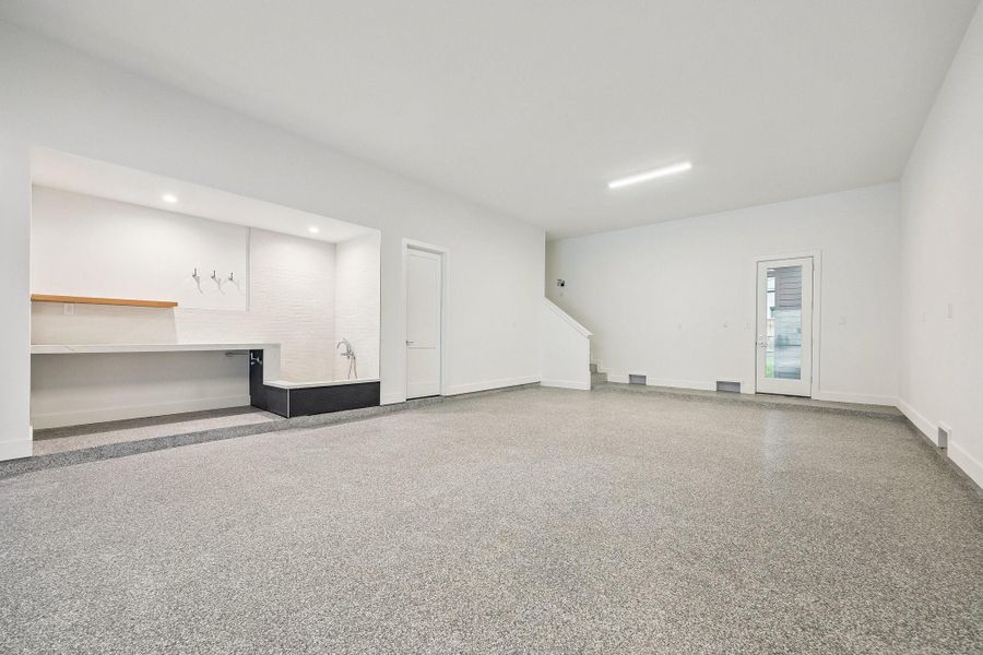 Incredible Four Car Garage with an Epoxy Treated Floor, plus extra storage and access to the elevator shaft. The Garage is also Pre-Wired for Two 220V Outlets.