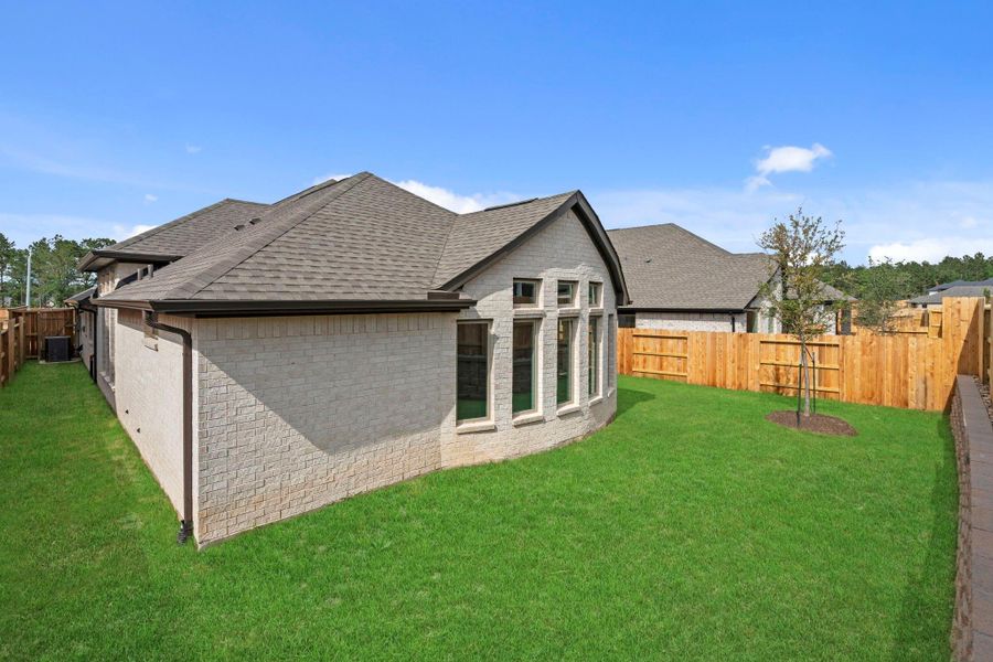 Exterior details and patio area of a home in Wildtree, Magnolia (Image 24).