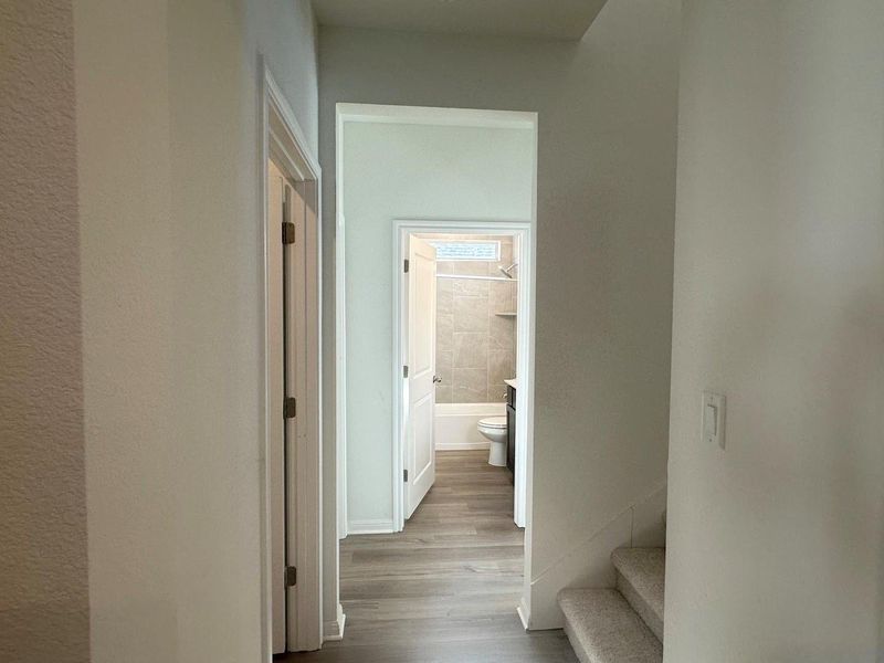 Corridor featuring wood finished floors and stairs Corridor featuring wood finished floors and stairs