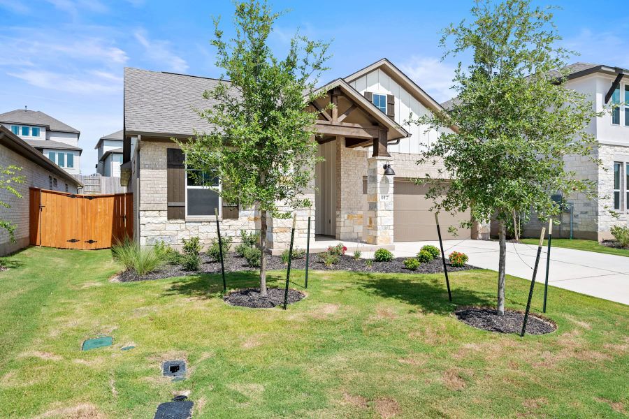 Front exterior of a new home in Lariat, Liberty Hill, TX, highlighting curb appeal (Image 23).