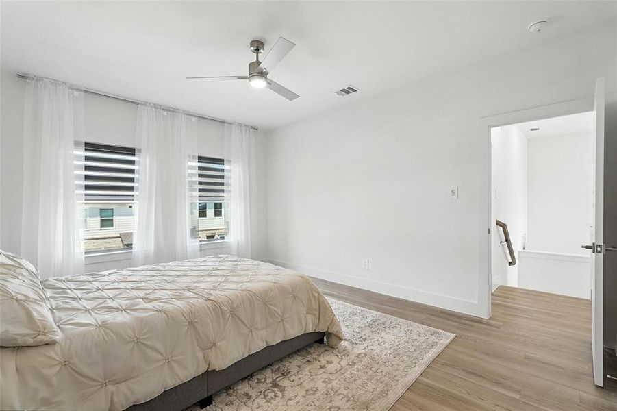 Bedroom with light wood-type flooring and ceiling fan