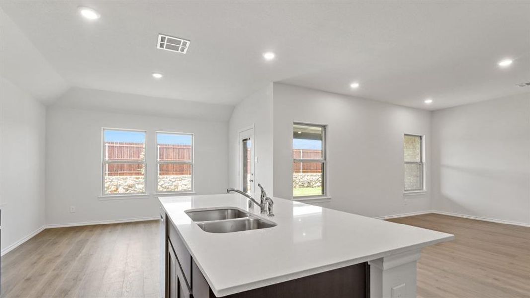 Kitchen island featuring a double-basin stainless steel sink and a contemporary faucet