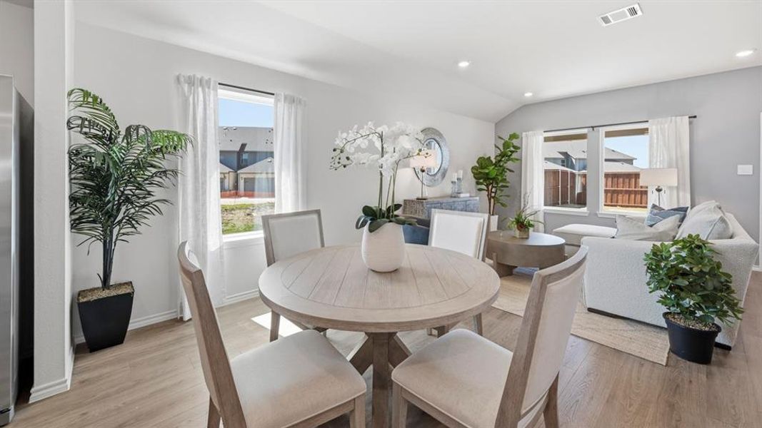 This open-concept living area features light-toned flooring and white walls, creating a bright and airy atmosphere