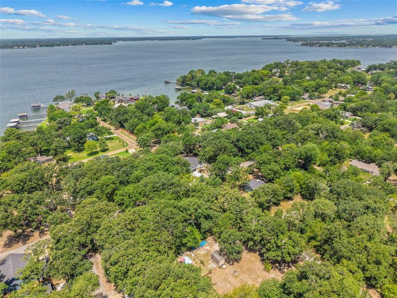 Expansive aerial perspective showcasing a significant body of water bordered by a verdant landscape Expansive aerial perspective showcasing a significant body of water bordered by a verdant landscape