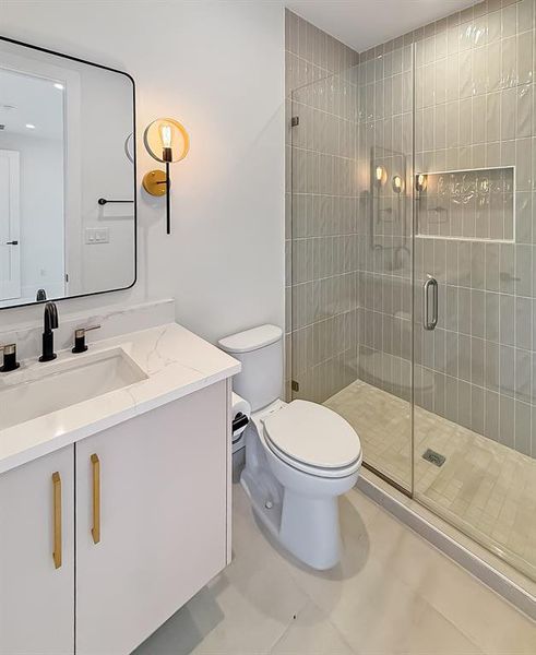 Full bathroom with vanity, a stall shower, and light tile patterned floors Full bathroom with vanity, a stall shower, and light tile patterned floors