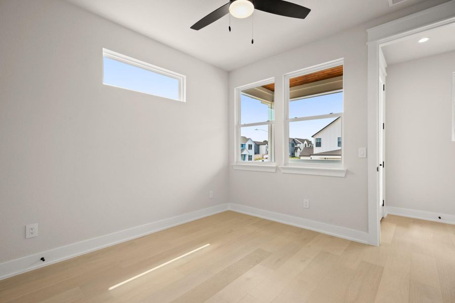 Spare room featuring baseboards and light wood-type flooring
