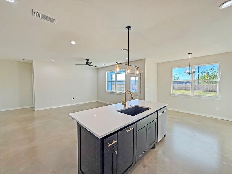 Kitchen with finished polished concrete flooring, recessed lighting, hanging light fixtures, open floor plan, and a ceiling fan