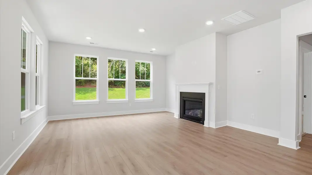 Highly skilled craftsmanship and modern elegance meet in this family room with soaring ceilings near Lake Hartwell