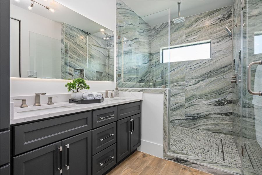 The shower suite boasts three heads—rainfall, wall-mounted, and handheld—surrounded by porcelain tile to the ceiling and framed by a bright window The shower suite boasts three heads—rainfall, wall-mounted, and handheld—surrounded by porcelain tile to the ceiling and framed by a bright window