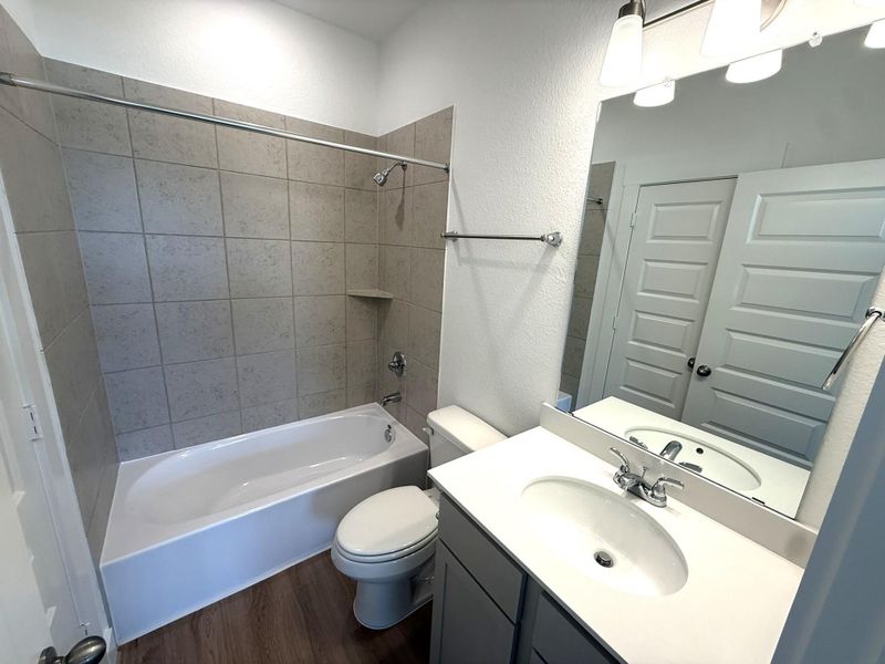 Featuring a combination tub and shower, ample counter space, and bright lighting, this space is perfect for kids, guests, or busy mornings.