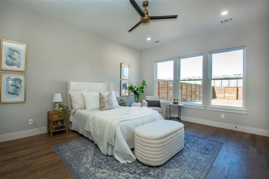 Bedroom featuring ceiling fan and dark wood-type flooring