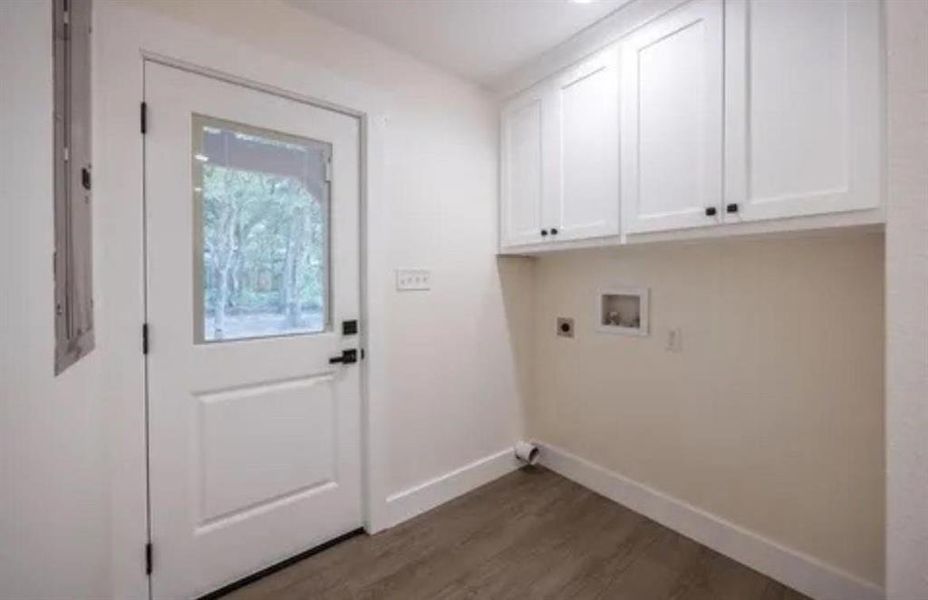 Laundry room with dark wood finished floors, cabinet space, hookup for a washing machine, and hookup for an electric dryer