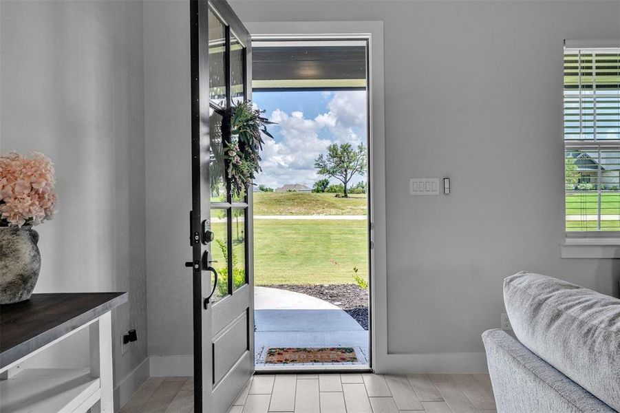 Full-light entry door with a multi-pane design and black hardware