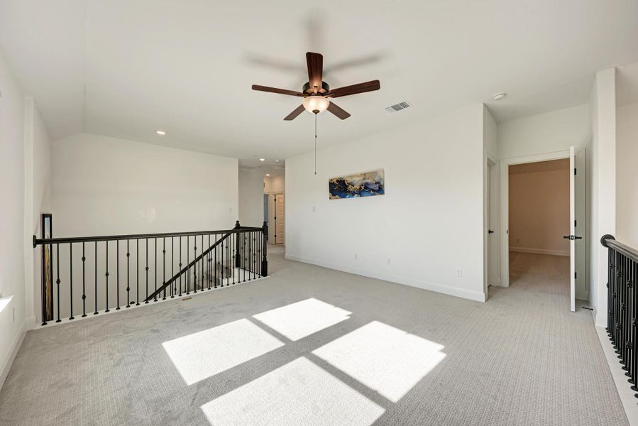 Carpeted empty room with ceiling fan and recessed lighting