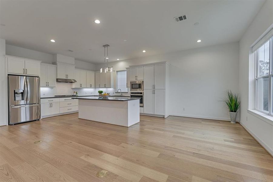 Seamless flow from the great room to the kitchen and dining area! Large block island boasts dining bar seating space!