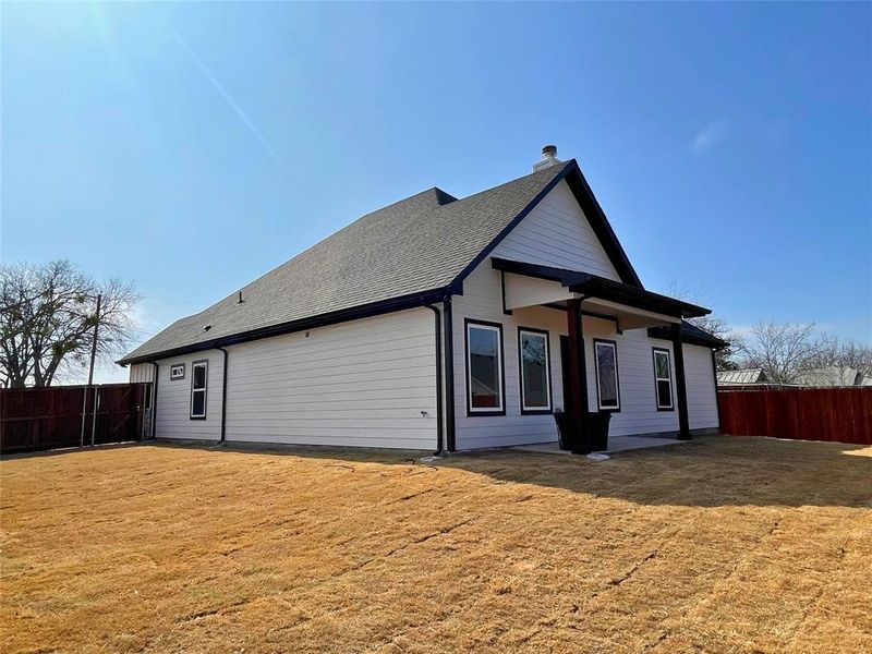 Rear view of house with a yard