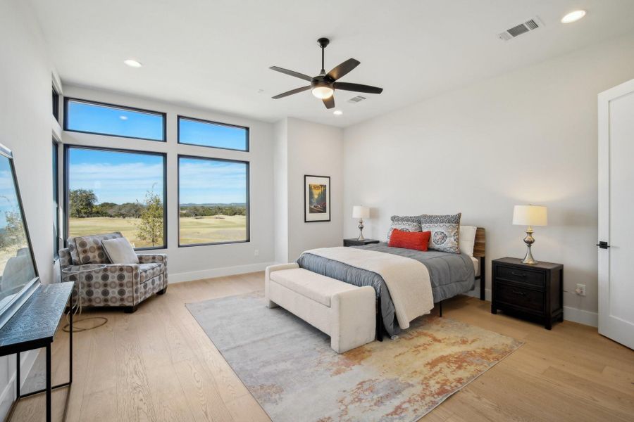 Primary bedroom offers hill country and golf course views.
