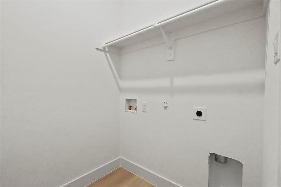 Laundry area with gas dryer hookup, light wood-type flooring, washer hookup, and hookup for an electric dryer