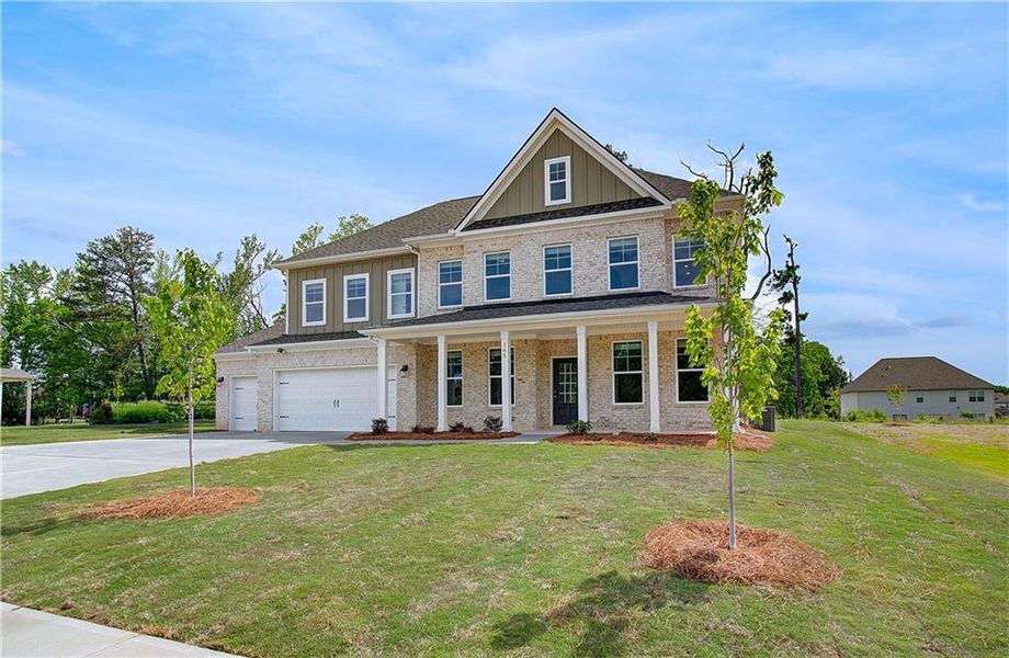 Front exterior of a new home in Cambria at Traditions, Hampton, GA, highlighting curb appeal (Image 17).