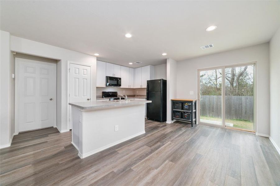 Featuring a sleek, oversized island perfect for meal prep or casual dining, this kitchen is a chef’s dream. The open layout connects effortlessly to the living space, making it ideal for family gatherings or entertaining friends.