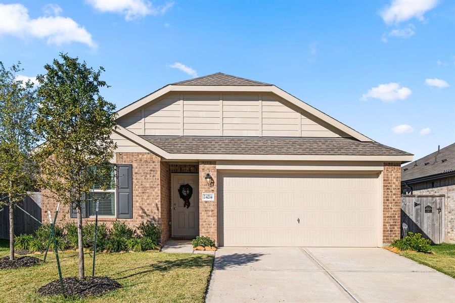 This charming single-story home features a well-kept landscaping, and a neat driveway, offering great curb appeal and a warm, inviting atmosphere.