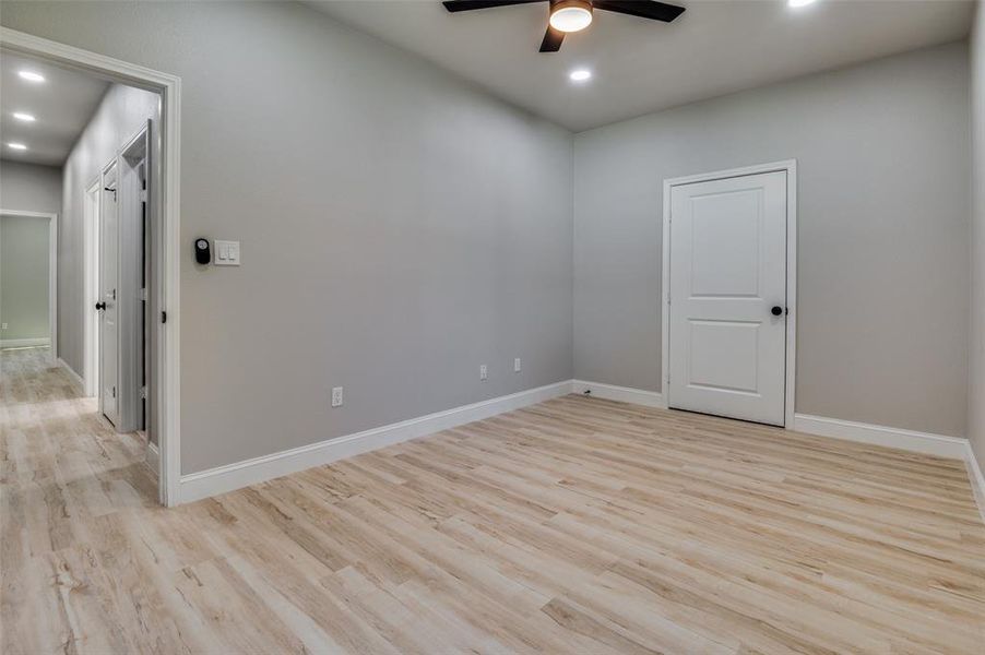 Empty room featuring light wood-type flooring, recessed lighting, and a ceiling fan Empty room featuring light wood-type flooring, recessed lighting, and a ceiling fan