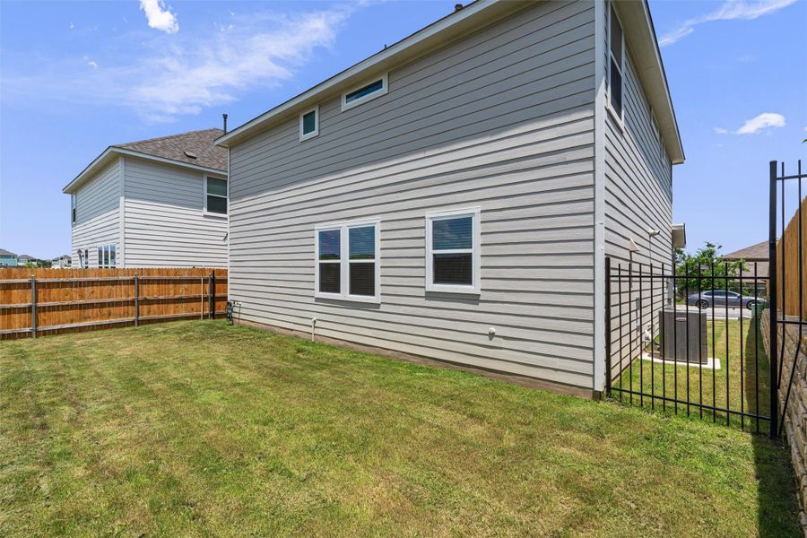 Rear view of house with a fenced backyard