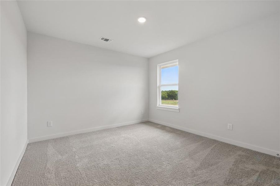 Spare room with carpet flooring, baseboards, and recessed lighting Spare room with carpet flooring, baseboards, and recessed lighting