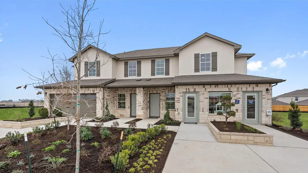 Front exterior of a new home in Palomino, Manor, TX, highlighting curb appeal (Image 2).