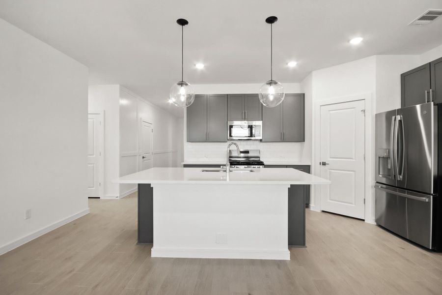 Stylish island kitchen (*Photo not of actual home and used for illustration purposes only.)