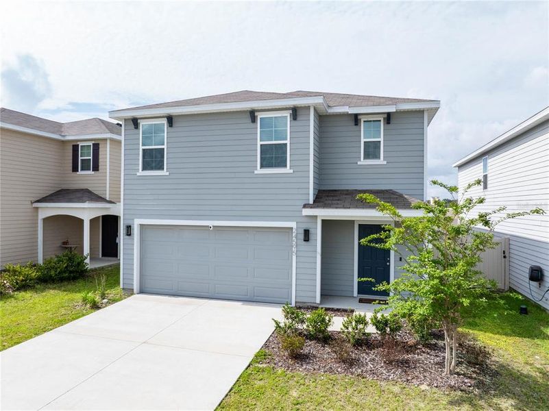 Front exterior of a new home in Avalon Woods, Newberry, FL, highlighting curb appeal (Image 22). Front exterior of a new home in Avalon Woods, Newberry, FL, highlighting curb appeal (Image 22).