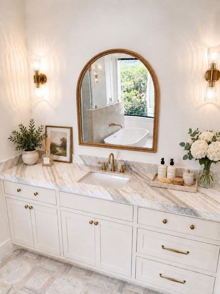 His vanity area with large run of marble countertop