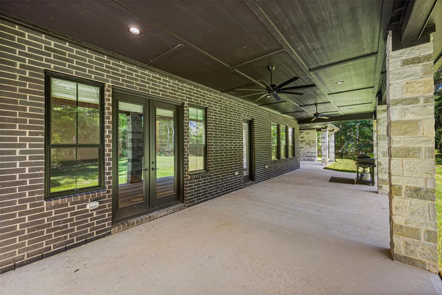 Multiple exterior doors open onto an expansive covered patio, creating a seamless transition to the home’s outdoor living spaces. Multiple exterior doors open onto an expansive covered patio, creating a seamless transition to the home’s outdoor living spaces.