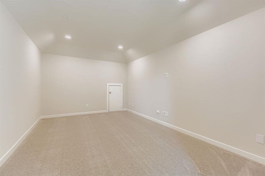 Unfurnished room with light carpet, recessed lighting, and lofted ceiling
