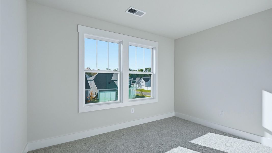 Refined bedroom design with large windows for daylight-filled mornings and peaceful views at Mulberry Estates
