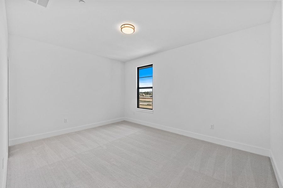 Unfurnished room featuring light colored carpet and baseboards