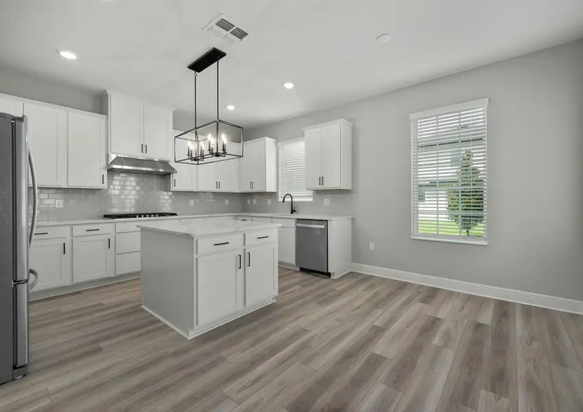 Kitchen with white cabinets and quartz countertops