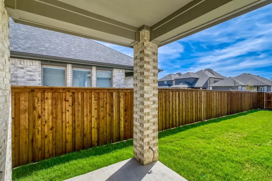 Fenced backyard with a patio and a residential view Fenced backyard with a patio and a residential view